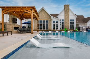 A pool with a slide in the middle of it.